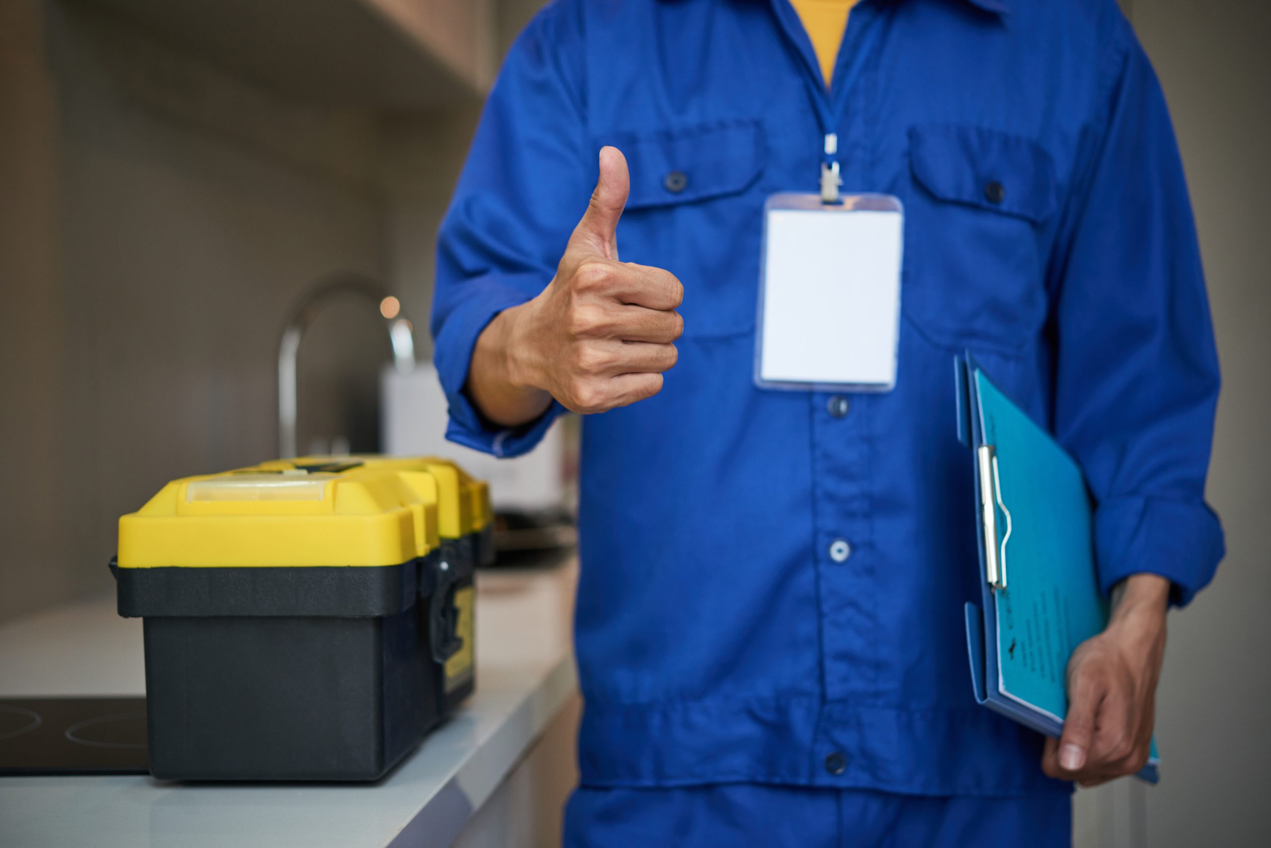 Picture related to Henderson https://waterdamagerestorationproslasvegas.com/wp-content/uploads/2023/01/unrecognizable-male-plumber-standing-near-kitchen-sink-showing-thumb-up-scaled.jpg